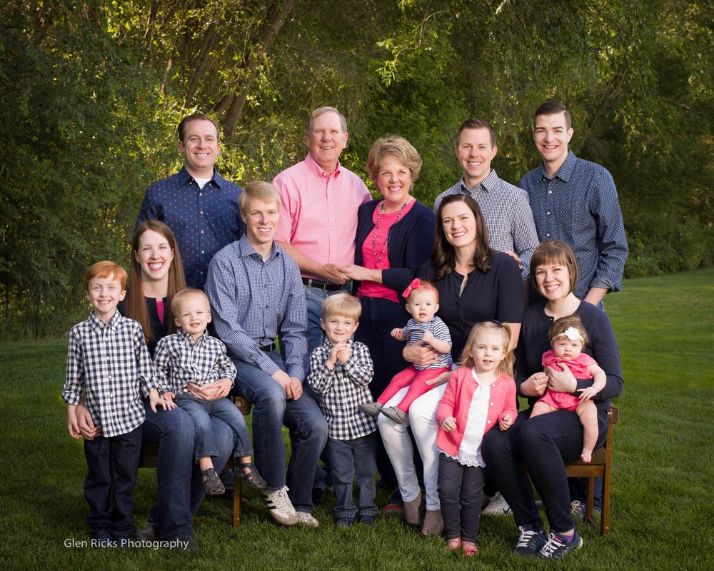 Dr. Dean Robinson and his family outdoors on lawn with trees in background